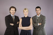 Three business people with arms crossed, portrait