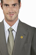 Businessman with gold star on suit, portrait