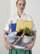 Office worker carrying personal belongings, indoors