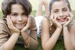 Boy and Girl Lying on Lawn