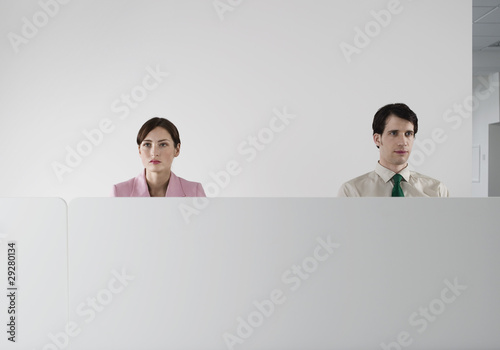 Photo: Office workers behind cubicle wall Office workers behind cubicle wall