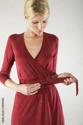 Photo: Woman Adjusting Belt Woman Adjusting Belt