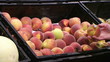 Woman Selecting Peaches In Produce