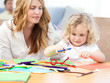 Woman and  her daughter cutting paper