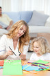 Woman and  her daughter cutting paper