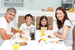 Photo: Family having breakfast in the kitchen Family having breakfast in the kitchen