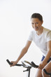 Young Woman Using Exercise Bike, portrait