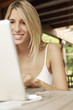 Photo: Young woman using laptop, portrait Young woman using laptop, portrait