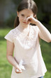 Little girl with cold rubbing eyes in backyard, portrait
