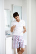 Man in bathroom considering taking medication