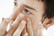 Man inserting contact lens, close up