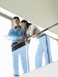 Two office Workers Reading Document on office balcony, view from below