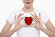 Photo: Woman in white t-shirt holding red glass heart in both hands Woman in white t-shirt holding red glass heart in both hands