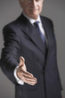 Businessman Offering Hand, half length
