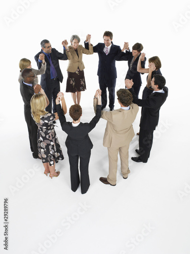 Photo: Group of Businesspeople in a circle, holding hands Group of Businesspeople in a circle, holding hands