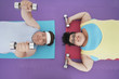 Photo: Overweight man and woman lying down lifting dumbbells, overhead view Overweight man and woman lying down lifting dumbbells, overhead view