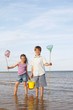 Girl and Boy Playing at Beach