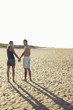 Couple Holding Hands on Beach