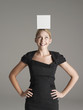 Young woman in black dress with white box on her head