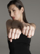 Young woman showing fists with 'hard work text, focus on foreground