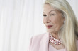 Senior woman winking in studio, head and shoulders