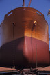 Large, Bronze and red ship in Dry dock