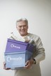 Senior Man Carrying Recycling Bin