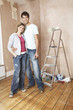 Couple embracing in unrenovated living room