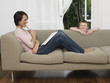 Mother and young son by couch