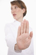 Woman holding up hand, studio shot