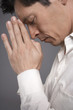 Man in white shirt praying, close-up, profile
