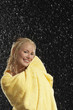 Smiling Woman Wrapped in Towel Standing in Rain