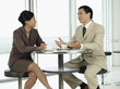 Businesspeople Sitting at table, talking to each other