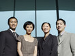 Confident Businesspeople group portrait, low angle view