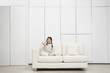 Young, barefoot Girl sitting cross-legged Sofa