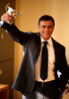 Businessman holding trophy