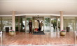 Bellboy delivering luggage to hotel with doorman standing by