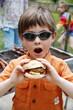 Young boy eating a hamburger