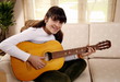 Teenage girl playing the guitar
