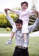 Man carrying a little boy on his shoulders