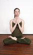 Young woman in a fitness class meditating