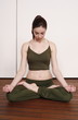 Young woman in a fitness class meditating