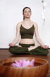 Young woman in a fitness class meditating