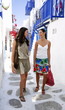 Two young women walking in alleyway