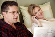 Mature couple relaxing in bed