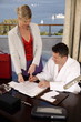 Two business people working in a hotel room