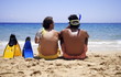 Two men with flippers on the beach