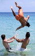 Three young men playing in the water