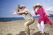 Senior couple with pineapples on the beach