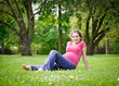 Photo: Beautiful pregnant woman in the park Beautiful pregnant woman in the park